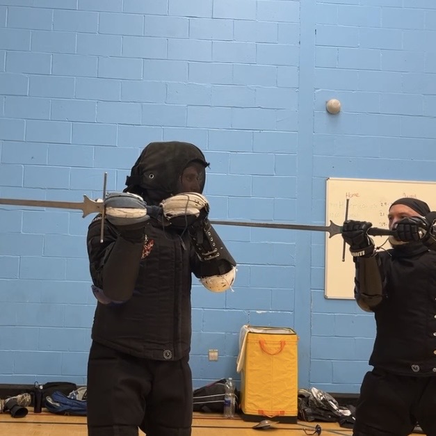 Olgun Tiltay learning Longsword basics from Cosmas Cieplak-Mayr von Baldegg HEMA instructor in Ausardia